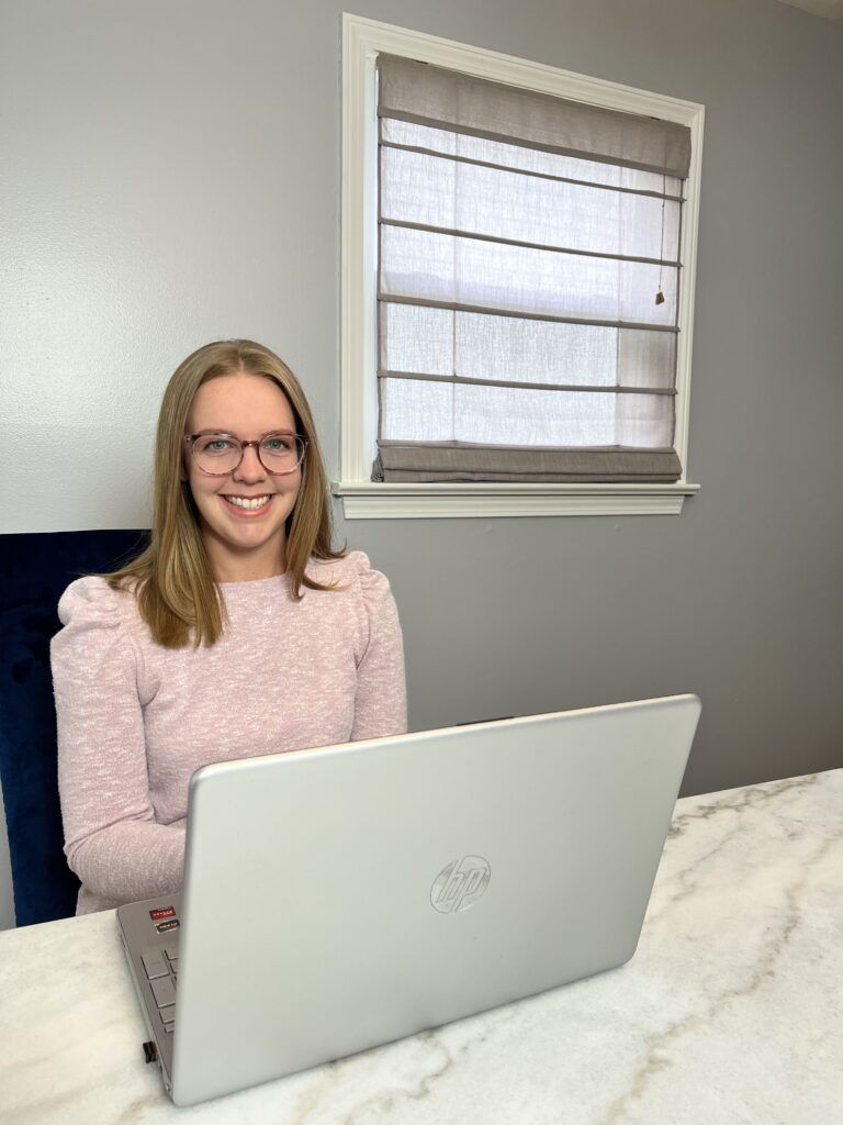 Sarah Robbins of AccentEquip smiling with laptop in front of her